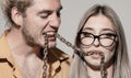 Couple of sexy man and sensual woman. Portrait of sexy coupl. Trendy look. Chains in mouth. Royalty Free Stock Photo