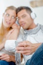 Couple sharing headphones listening to cellphone Royalty Free Stock Photo