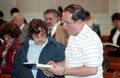 Couple shar ing a hymnal at a Baptist church service in Bladensburg, Maryland