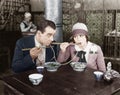 Couple sharing a noodle in a restaurant Royalty Free Stock Photo