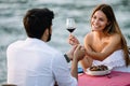 Couple sharing romantic sunset dinner on the beach Royalty Free Stock Photo