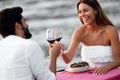 Couple sharing romantic sunset dinner on the beach Royalty Free Stock Photo