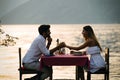 Couple sharing romantic sunset dinner on the beach Royalty Free Stock Photo