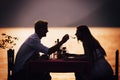 Couple sharing romantic sunset dinner on the beach Royalty Free Stock Photo