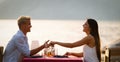 Couple sharing romantic sunset dinner on the beach Royalty Free Stock Photo