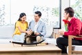 Couple with shop assistant in furniture store Royalty Free Stock Photo