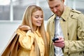 Couple of shopaholics stand outside after shopping Royalty Free Stock Photo