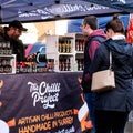 Couple Shopping At A Chilli Vegan Market Stall