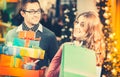 Couple shopping Christmas presents and bags in mall Royalty Free Stock Photo