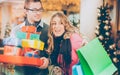 Couple shopping Christmas presents and bags in mall Royalty Free Stock Photo