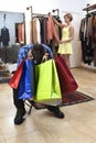Couple shopping with man tired and bored holding bags and woman happy looking for dress Royalty Free Stock Photo