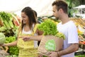 Couple shopping at open street market. Royalty Free Stock Photo