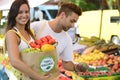 Couple shopping at open street market. Royalty Free Stock Photo