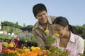 Couple Shopping at Plant Nursery smelling flowers Royalty Free Stock Photo