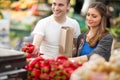 Couple shopping red pepper in grocery store Royalty Free Stock Photo