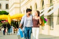 Couple shopping and spending money in city