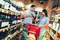 Couple shopping in supermarket buying wines