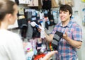 Couple shops at store buying socks Royalty Free Stock Photo