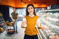 Couple at the showcase with milk in grocery store