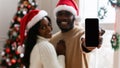 Couple showing empty smartphone screen, Xmas offer Royalty Free Stock Photo