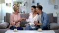 Couple showing engagement ring to future mother-in-law, happy family relations Royalty Free Stock Photo