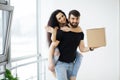 Couple showing keys to new home hugging looking at camera Royalty Free Stock Photo