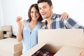 Couple showing keys to new home hugging looking at camera Royalty Free Stock Photo