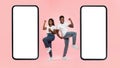 Couple showing white empty smartphone screen and making win gesture Royalty Free Stock Photo