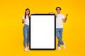Couple showing white empty tablet screen and gesturing yes Royalty Free Stock Photo