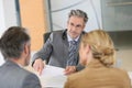 Couple signing contract in lawyer's office Royalty Free Stock Photo