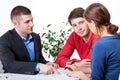 Couple signing the mortgage agreement Royalty Free Stock Photo