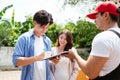 A couple signs the checklist of Asian and Caucasian workers in uniform unloading cardboard boxes from the truck. Delivery men Royalty Free Stock Photo