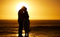 Couple, siilhouette and kiss at sunset on a beach for vacation, holiday or mockup outdoor. Romantic man and woman in Royalty Free Stock Photo