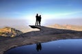 Couple silhouette on the edge of a cliff Royalty Free Stock Photo