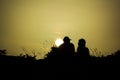 Couple silhouette watching the sun at sunset at Sounion