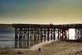 Couple Silhouetted on a Pier at the Beach during sunset Royalty Free Stock Photo