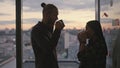 Couple silhouettes drinking coffee sunset place closeup. Unknown people talking