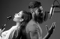Couple singing. Singer friends singing rock. Sound producer recording song in a music studio. Excited Karaoke. Royalty Free Stock Photo