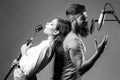 Couple singing. Singing man and girl in a recording studio. Expressive couple with microphone. Karaoke signer, musical Royalty Free Stock Photo