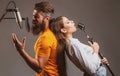 Couple singing. Singing man and girl in a recording studio. Expressive couple with microphone. Karaoke signer, musical Royalty Free Stock Photo