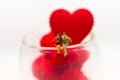 The couple sit at the edge of a glass with a glass full of heart