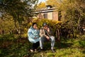 Couple sit on old rusty bed in autumnal garden