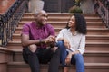 Couple Sit And Talk On Stoop Of Brownstone In New York City Royalty Free Stock Photo