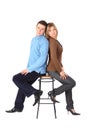 Couple sits on bar stool back to back Royalty Free Stock Photo