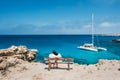 Loving couple sitting on a bench and looks at the lagoon Royalty Free Stock Photo