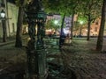 Couple sits on bench in Paris evening at Place Emile Goudeau on Montmartre