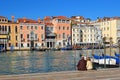 Couple sits on the waterfront of Grand Canal in Venice