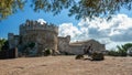 A couple sittin on a bench, near the fortified walls