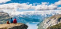 Couple sitting against amazing nature view on the way to Trolltunga. Location: Scandinavian Royalty Free Stock Photo