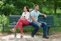 Couple Sitting Back To Back On Bench Royalty Free Stock Photo